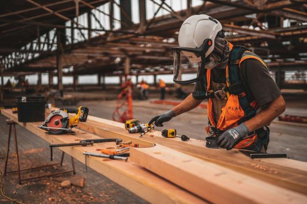 Image of a person working in a construction site, wearing all the necessary PPE equipment